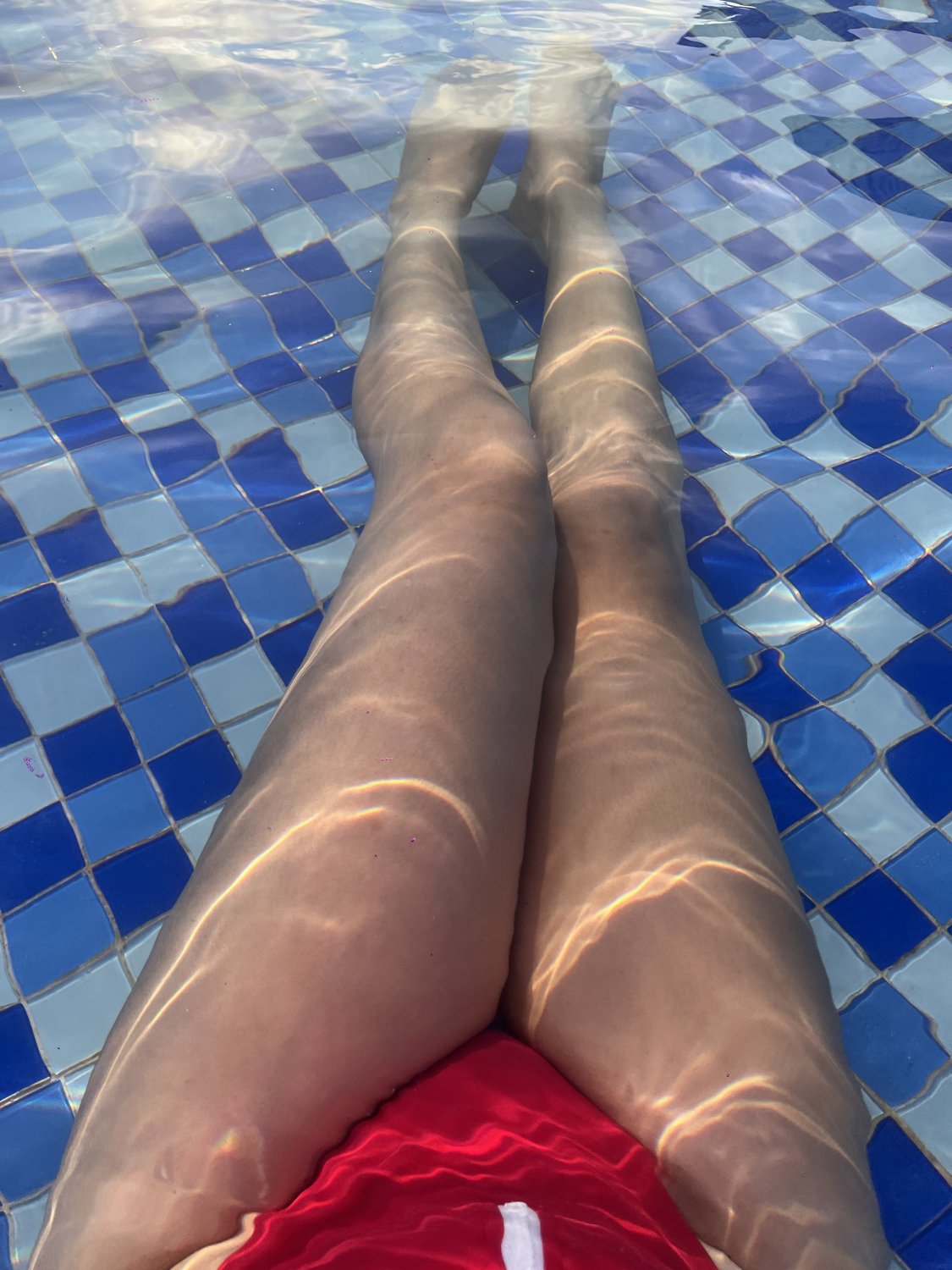 Legs and feet, wading in a Sanya swimming pool #hgS9zZE8